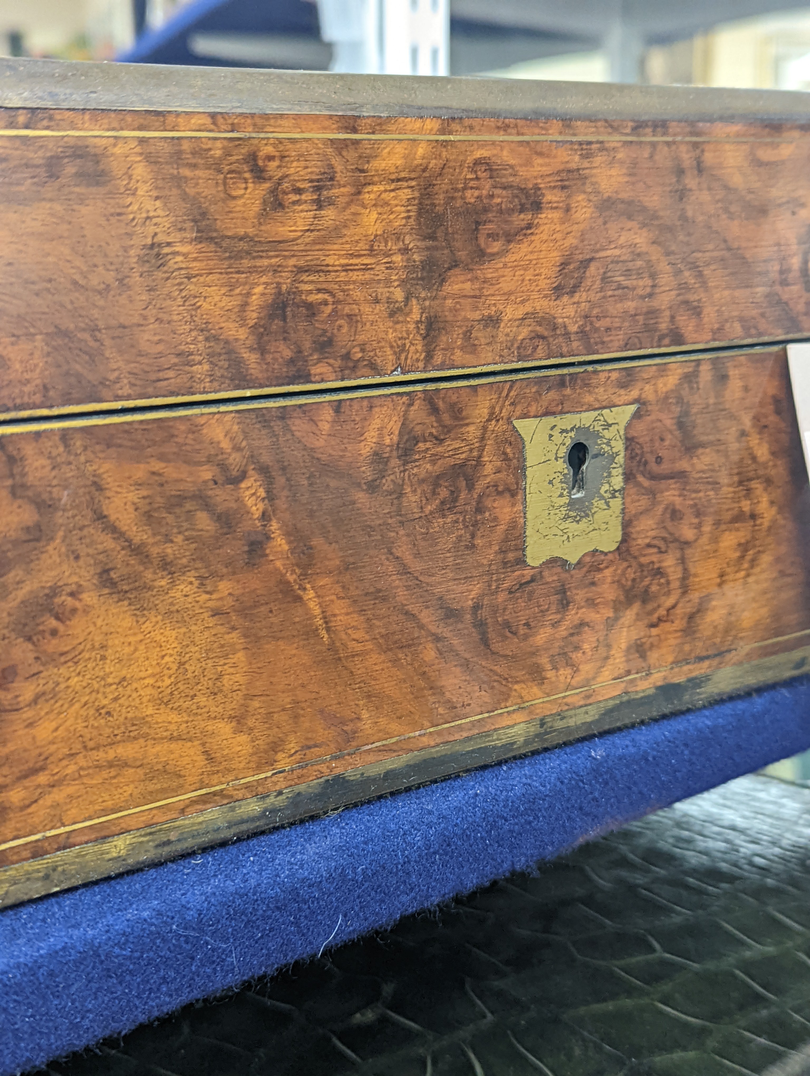 A Victorian brass mounted burr walnut toilet box, fitted with glass jars with electroplated tops, Width 30 cms. Ivory mounted items included